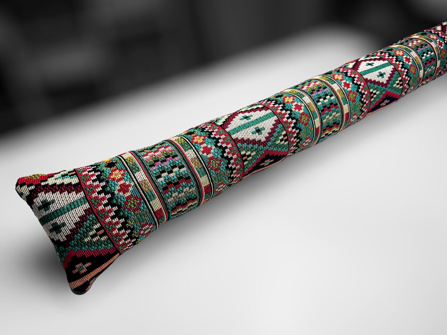 Handmade Indian tapestry draught excluder featuring intricate red and gold patterns for farmhouse decor.