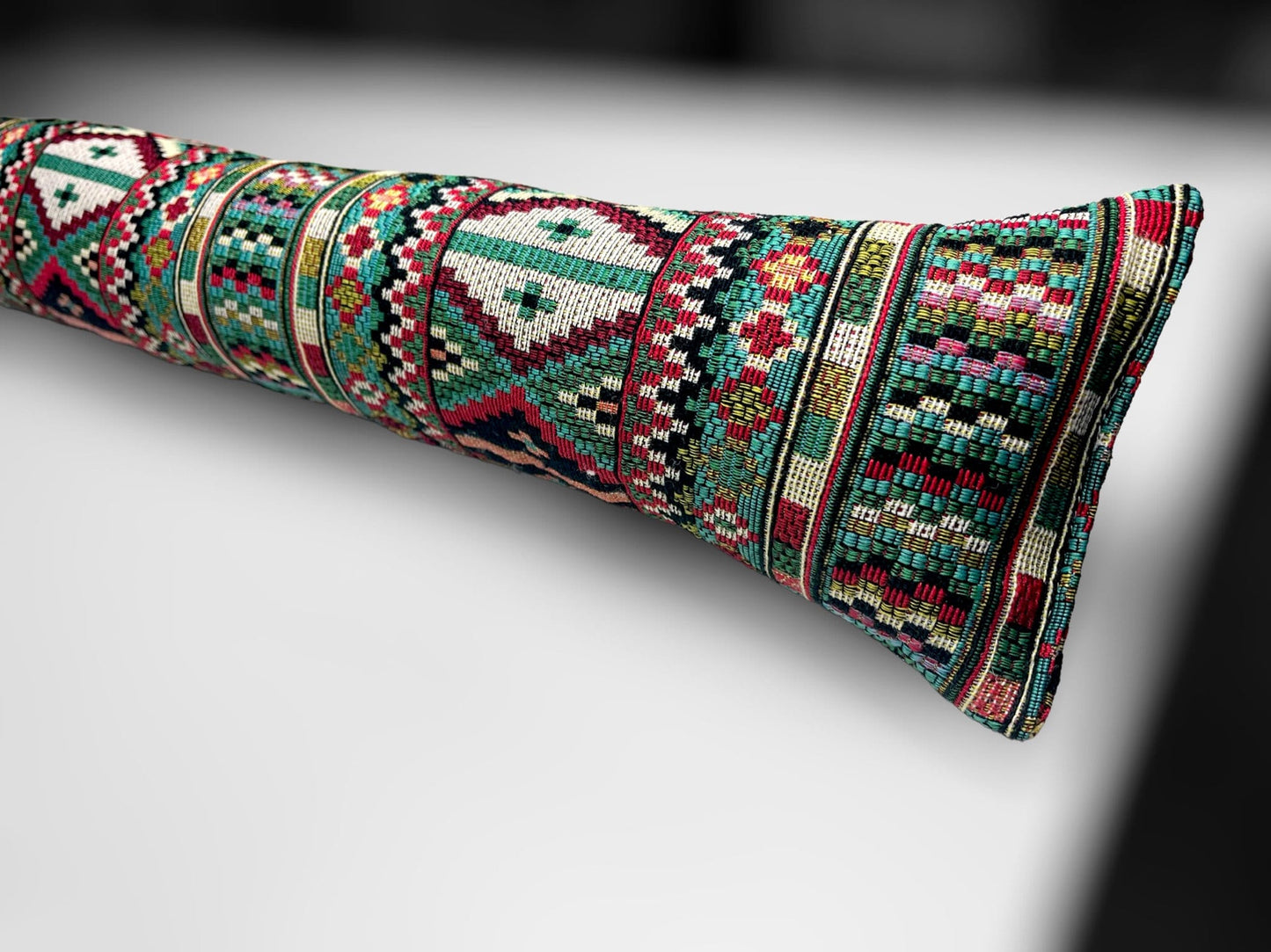 Handmade Indian tapestry draught excluder featuring intricate red and gold patterns for farmhouse decor.