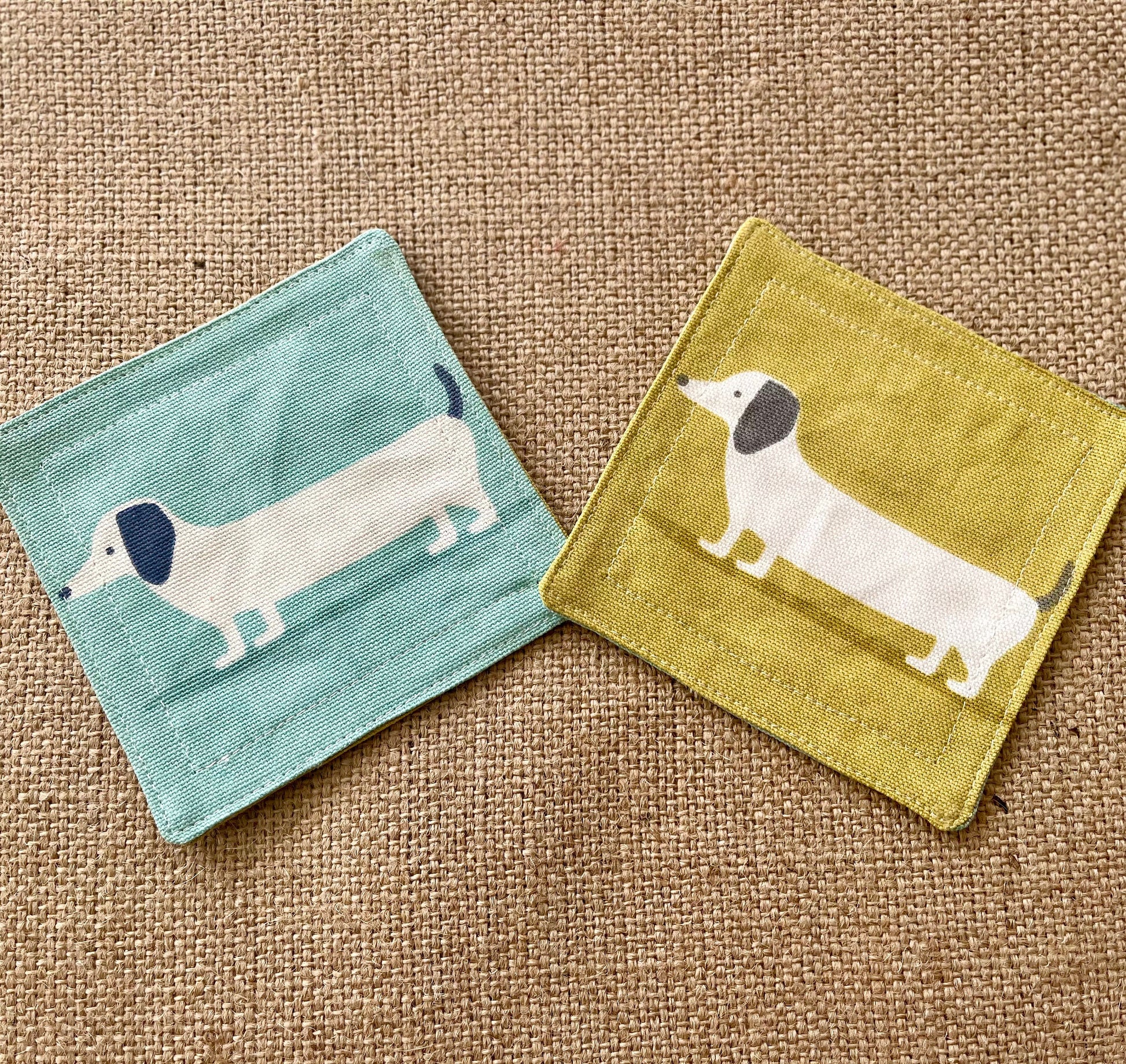 Blue and Yellow Dachshund Print Fabric Coasters Double Sided Set of 2. Sausage dog print reversible different colour on each side.