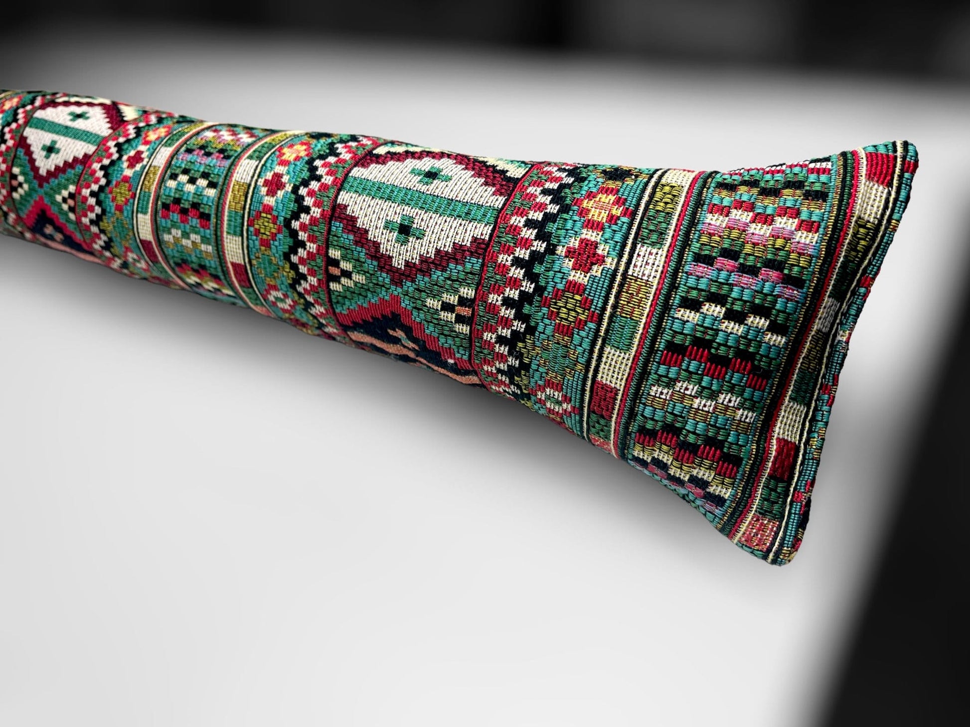 Handmade Indian tapestry draught excluder featuring intricate red and gold patterns for farmhouse decor.