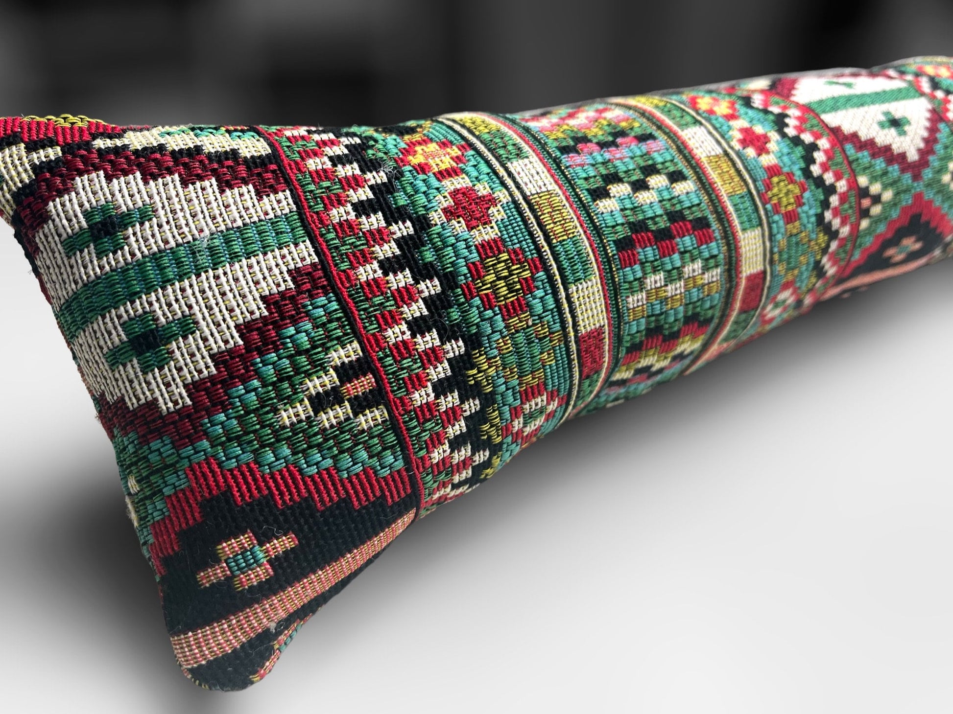 Handmade Indian tapestry draught excluder featuring intricate red and gold patterns for farmhouse decor.