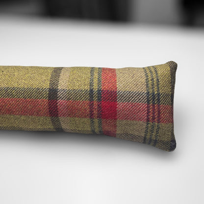 Handmade wool tartan draught excluder in green, red, and brown tones, designed to block drafts under doors.