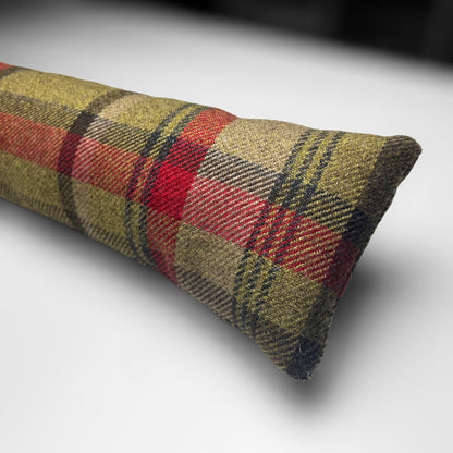 Handmade wool tartan draught excluder in green, red, and brown tones, designed to block drafts under doors.